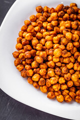 fried chickpeas on a dark stone background