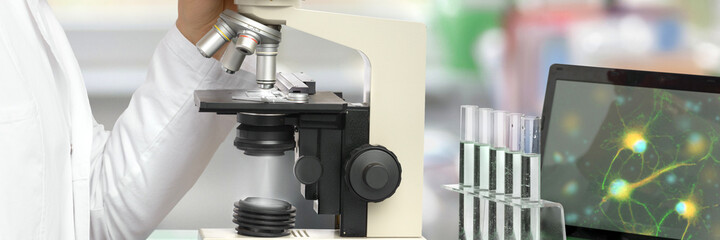 Male researcher with microscope in modern research facility