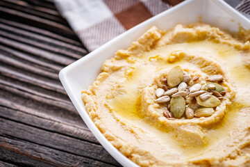 traditional turkish hummus on a dark wooden rustic background