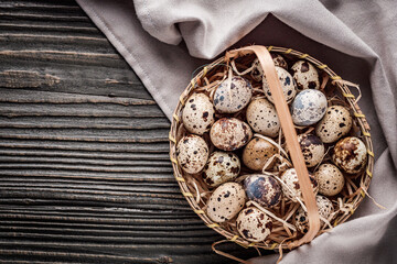 fresh quail eggs on a dark wooden rustic background