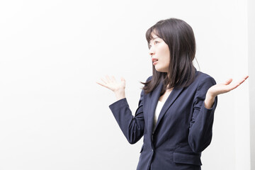 Woman sanding and shrug her shoulders (gesture)