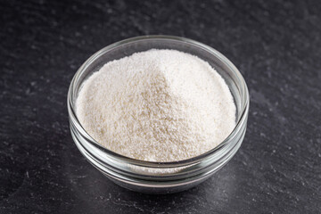 granulated milk powder on a dark stone background