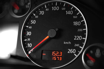 Luxury car speedometer close up. Speedometer arrows in dark colors.