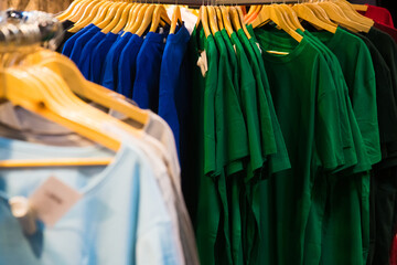 Obraz premium T-shirts on hangers in the store