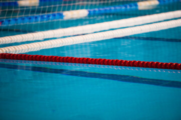 The view of an empty public swimming pool indoors