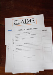 Insurance Claim form put on wood board