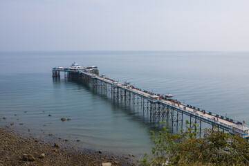 Fototapeta premium Llandudno pier in summer. North Wales tourist destination. Old victorian pier