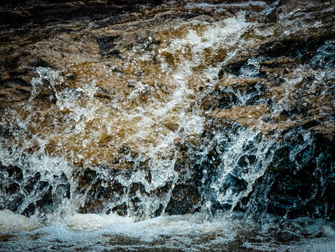 High Shutter Speed Water Flowing From A Rock