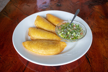 fried empanadas with hot sauce