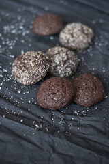 Chocolate chip cookies with coconut. Lie on a black and gray background.