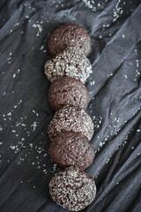 Chocolate chip cookies with coconut. Lie on a black and gray background.