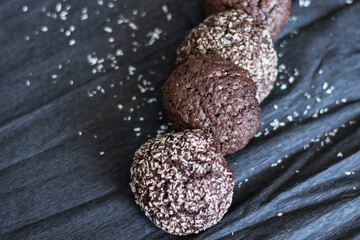 Chocolate chip cookies with coconut. Lie on a black and gray background.