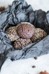 Chocolate chip cookies with coconut. Lie on a black and gray background.