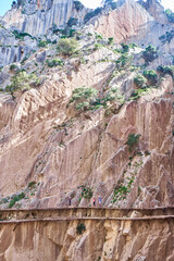 Very narrow path in rocky canyon - mountain wooden path along steep cliffs in Andalusia, Spain