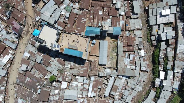 Aerial view of people playing on a rooftop in Kibera, largest slum in Africa