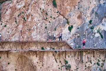 Very narrow bridge in rocky canyon - mountain wooden path along steep cliffs in Andalusia, Spain