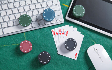 Computer keyboard, mouse, playing cards and chips. Online casino