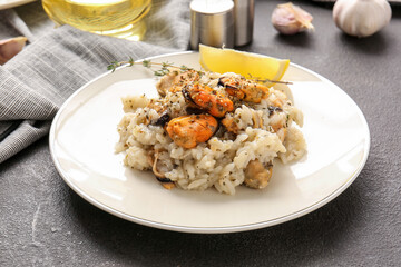Plate with tasty risotto on dark background