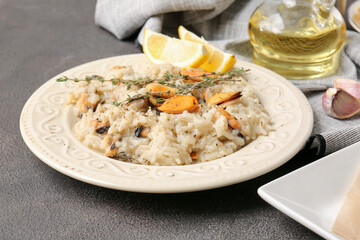 Plate with tasty risotto on dark background