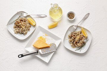 Plates with tasty risotto on light background