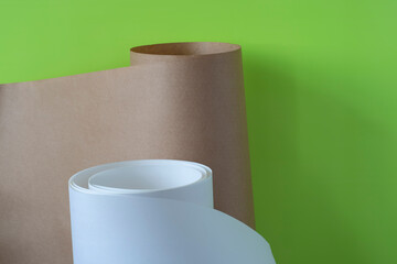 Roll of brown and white paper on a green background.