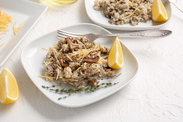 Plate with tasty risotto on light background