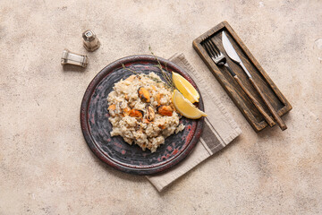 Plate with tasty risotto on grunge background