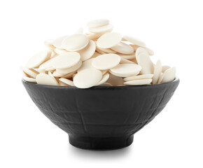 Bowl with chocolate drops on white background