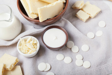 Bowls with white chocolate on fabric background