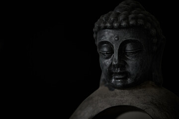 Fototapeta na wymiar Buddha sculpture isolated on black background
