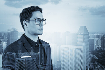 Young handsome businessman in suit and glasses dreaming about new career opportunities after MBA graduation. Singapore on background. Double exposure.