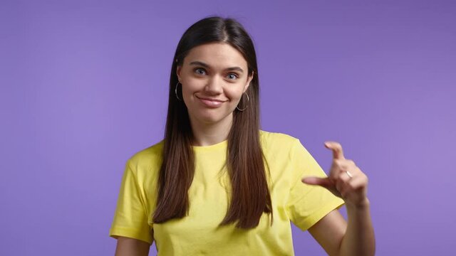 Young woman showing difference between invisible abstract subject or object sizes. Big large and small tiny concept. 