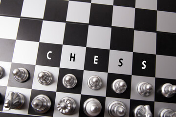 Gold and silver chess game on white background. A soldier confronts the opponent