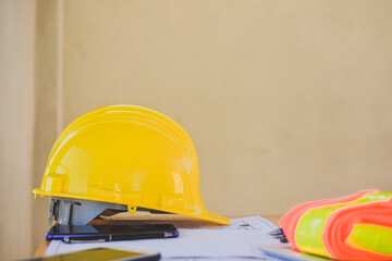 Yellow hard hat safety for engineering on desk in office