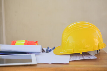 Yellow hard hat safety for engineering on desk in office