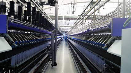 Close-up of the machines that produce thread . Factory for the production of threads and fabrics