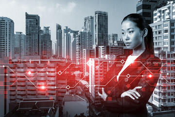 Attractive young Asian businesswoman pondering on technology at business process to achieve...