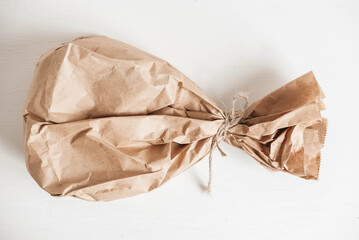 Full disposable bag of brown kraft paper on a white background. Top view. Copy, empty space for text