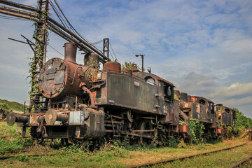 Fototapeta na wymiar Old and rust steam abandoned classic train