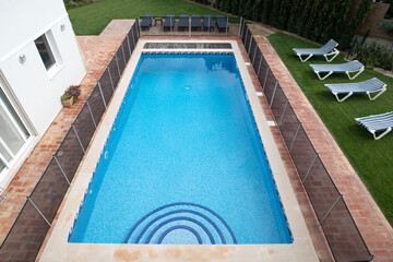 High angle view of a swimming pool with child safety fence around it