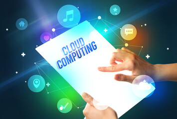 Holding futuristic tablet with CLOUD COMPUTING inscription, new technology concept