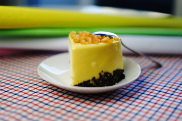 Mousse cake with marmalade on a white plate