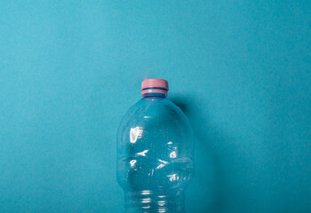 Plastic bottles crushed on the blue background. Recycling concept