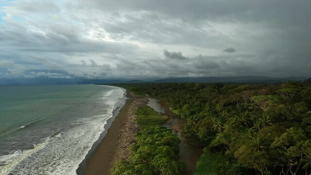 aerial shot storm clouds with a rainbow over the jungle Costa Rica sunset pavon bay