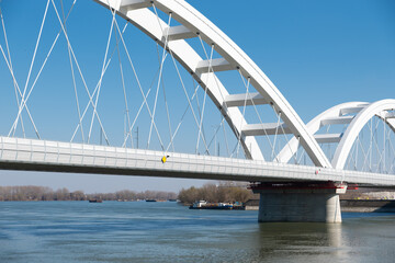 Concrete construction of a new bridge with arches above the water Novi Sad, Serbia