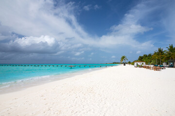 tropical Maldives island with white sandy beach and sea