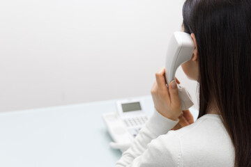 Woman talking on landline (back view)
