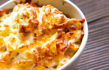 French cuisine is julienne. with mushrooms, in white form close-up