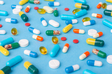 Background of different colorful pills and capsules. Medicine and treatment concept
