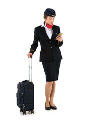 Female flight attendant with a suitcase standing and waiting isolated on white background